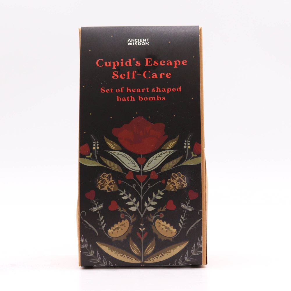 Box of 'Cupid's Escape Self-Care' heart-shaped bath bombs with floral design on a white background