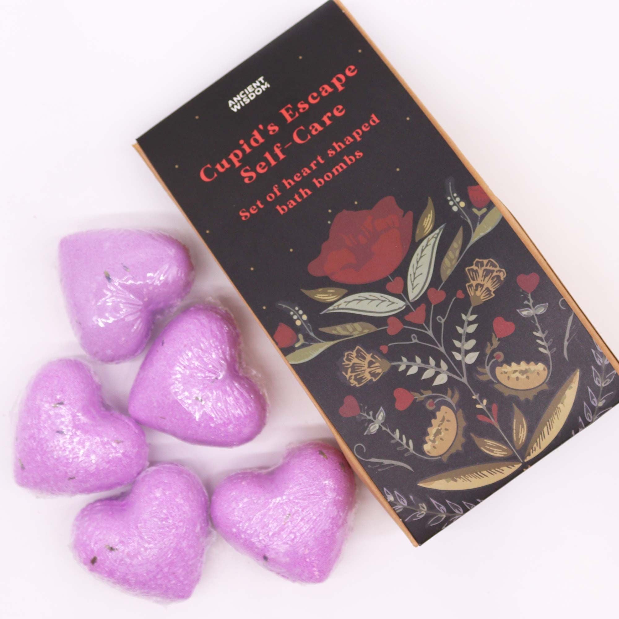 Purple heart-shaped bath bombs with a decorative box on a white background
